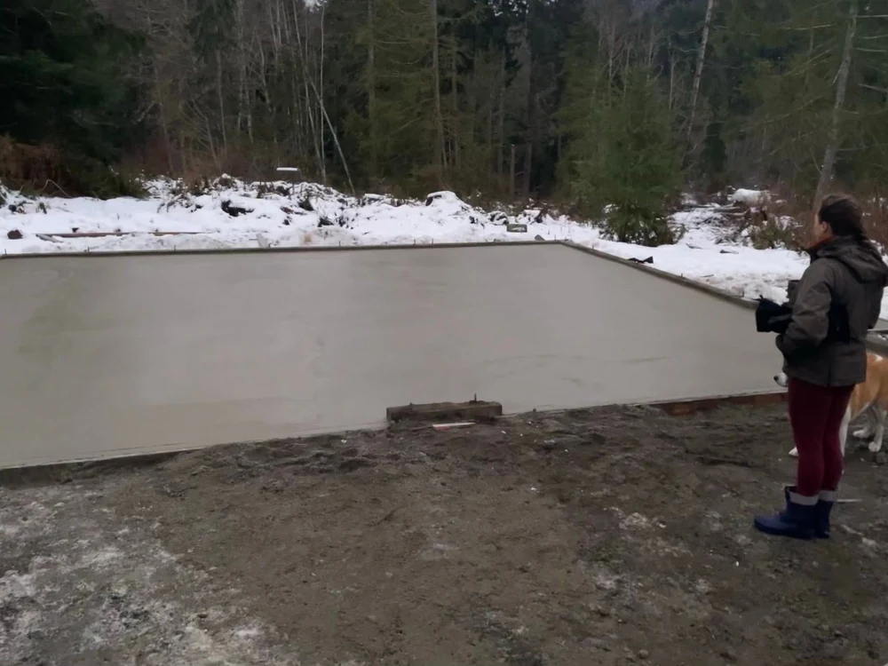 Freshly poured concrete slab foundation on a cleared building site by CKS Builders LLC in Port Angeles, WA