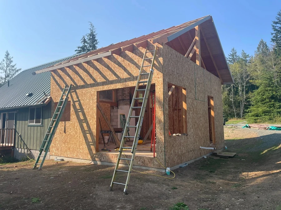 Complex roof framing with new rafters tying into an existing roofline, by CKS Builders LLC