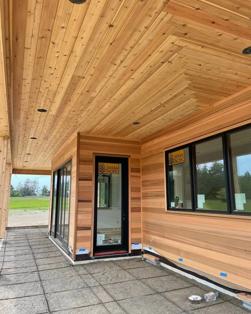 Cedar soffit, cedar siding, and window trim on a covered patio finished by CKS Builders LLC