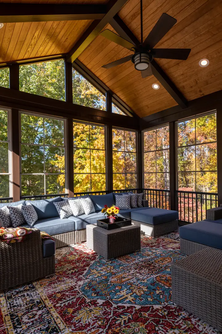 Sunroom addition with a vaulted wood ceiling and wraparound windows