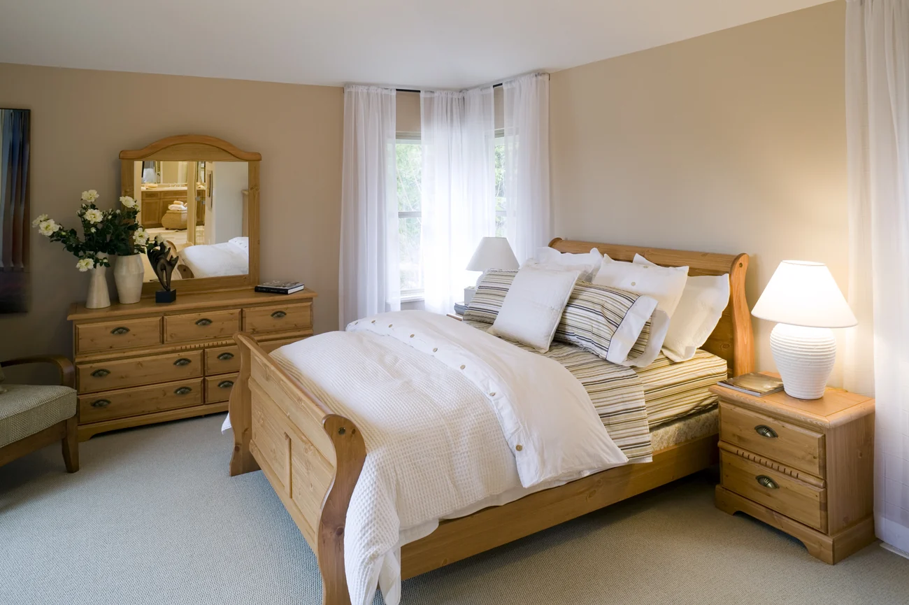 Bedroom addition with a large window and wood furnishings