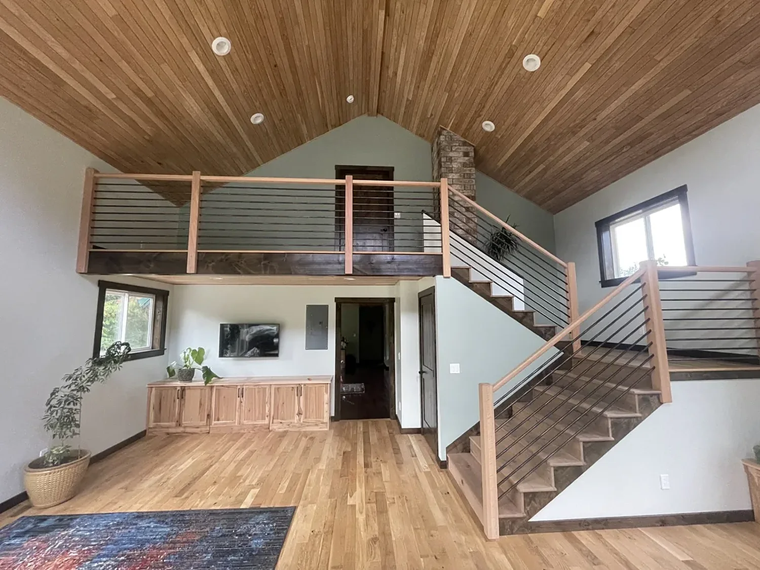 Home addition with a vaulted cedar ceiling and open loft
