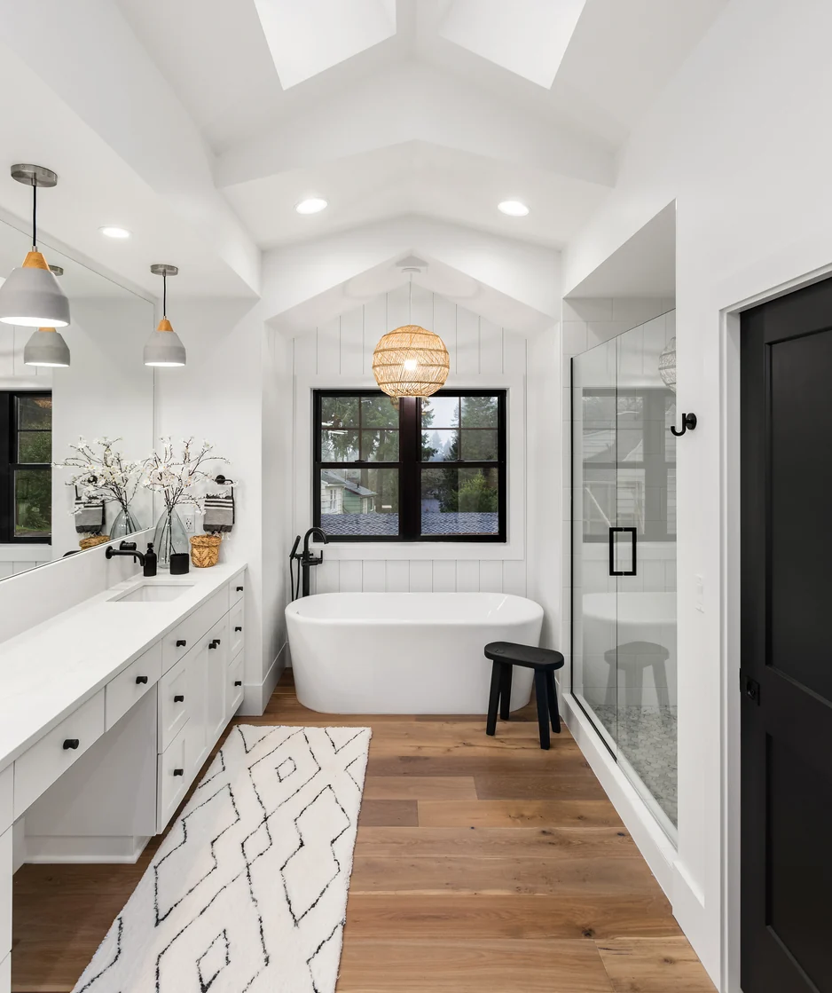 Primary bathroom with a freestanding tub and a separate glass shower enclosure set along one long vanity wall