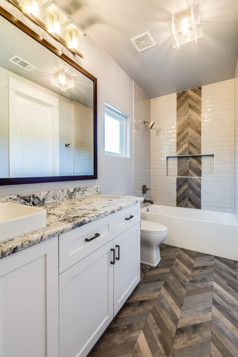Compact bathroom where one combined tub and shower shares a single wall with the vanity and toilet