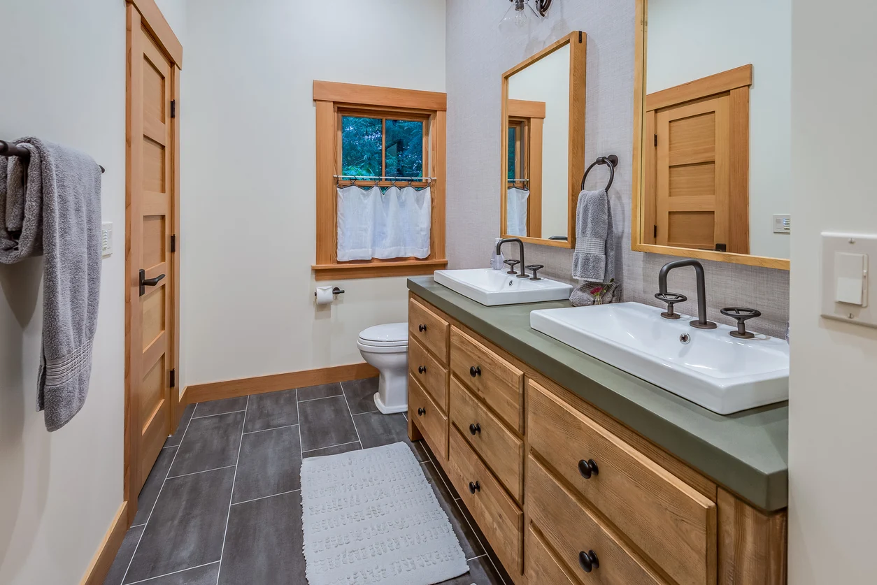 Remodeled bathroom with a double vanity and tile flooring