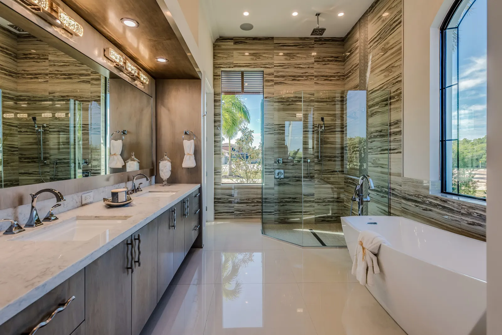 Large primary bathroom with a double vanity, a glass walk-in shower, and a freestanding tub