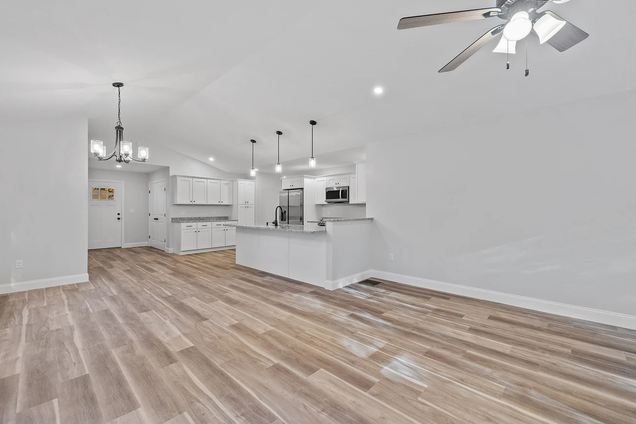 Kitchen peninsula with a raised counter separating the kitchen from an open living area