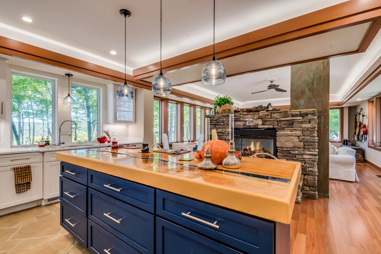 Remodeled kitchen with a large island, stone surround, and updated cabinetry