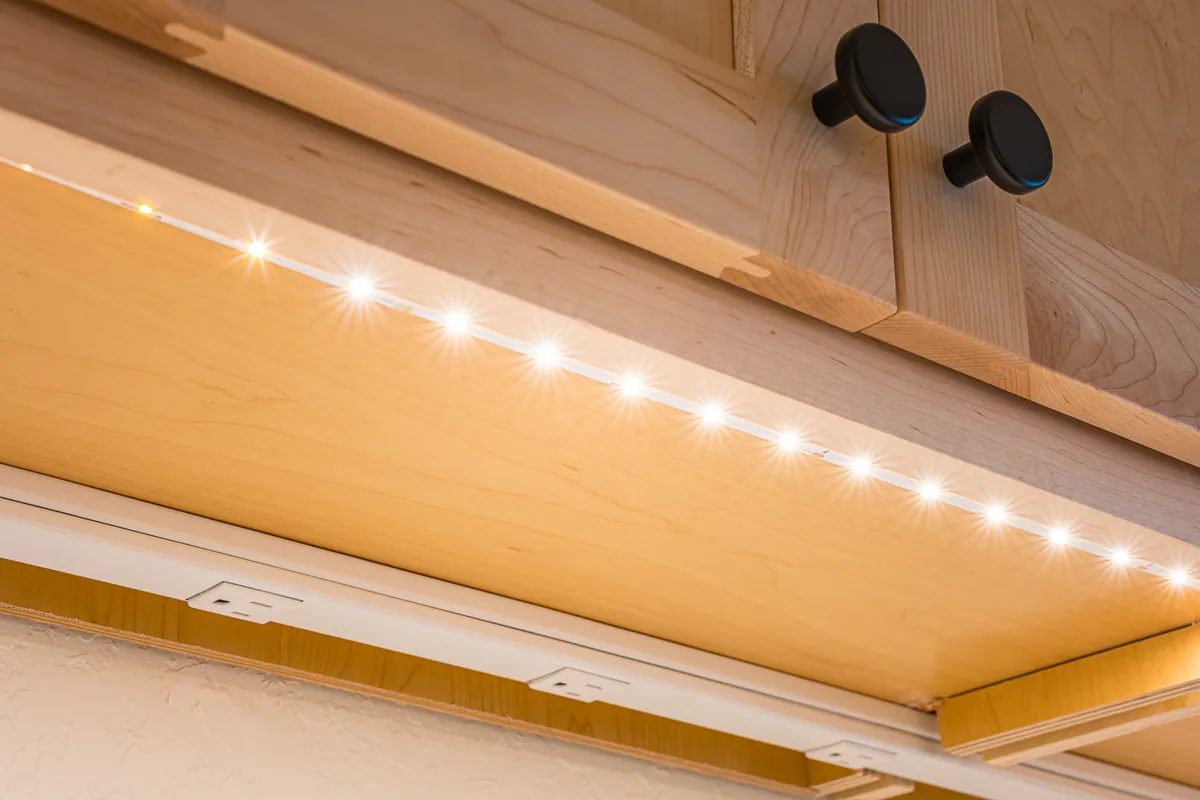 LED strip lighting under maple kitchen cabinets, a detail from a remodel by CKS Builders LLC