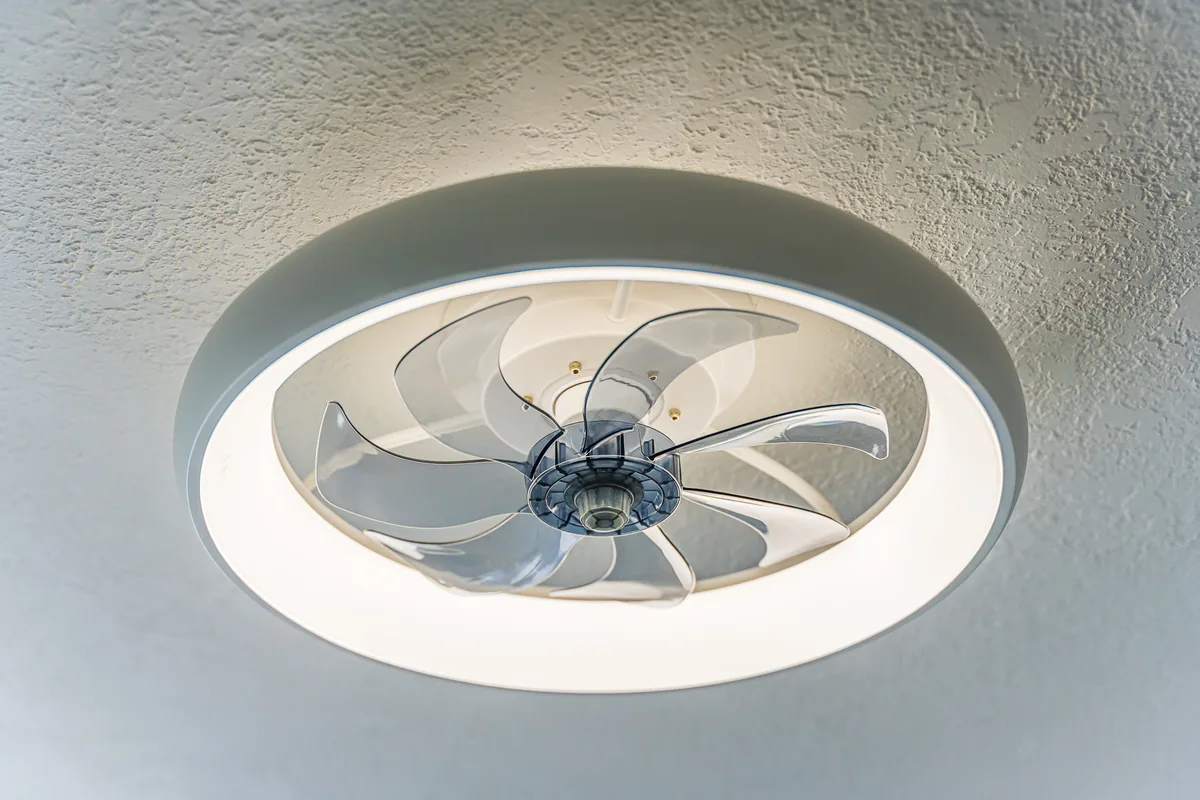Low-profile ceiling fan with a ring light, a finish detail from a remodel by CKS Builders LLC