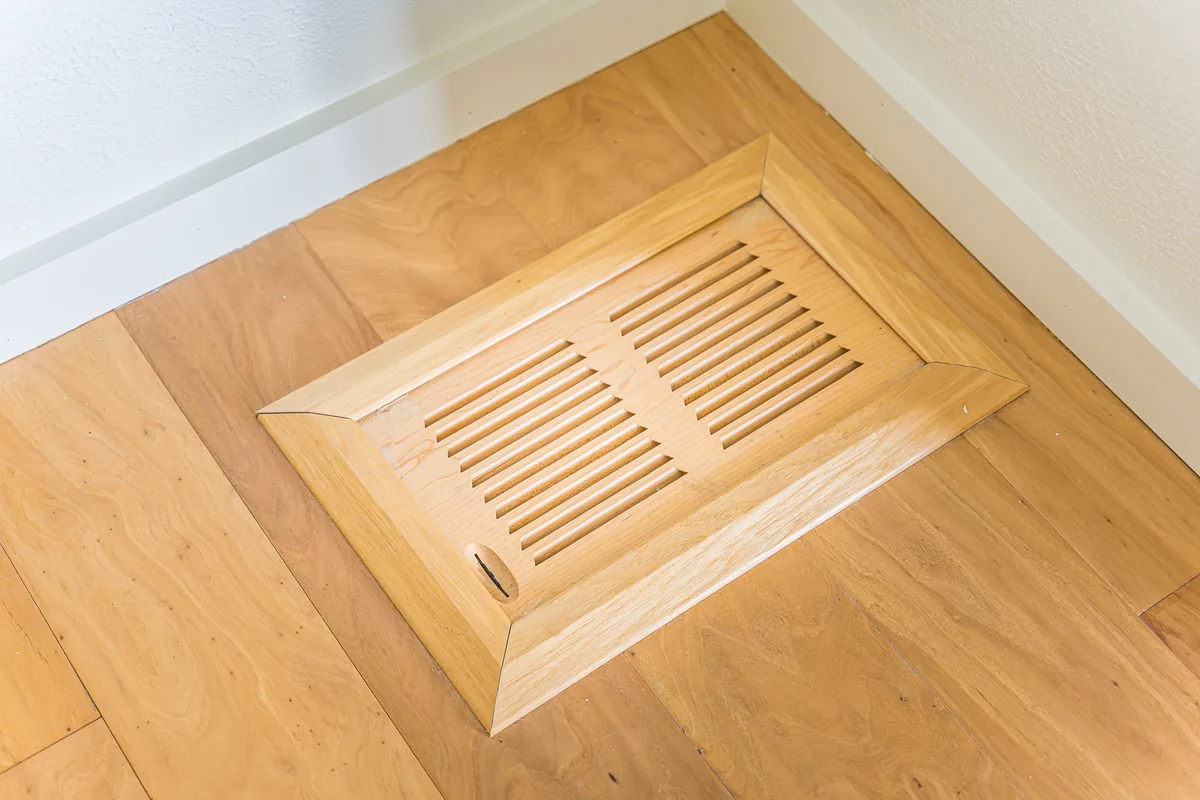Flush wood floor vent set into wood flooring, a finish detail from a remodel by CKS Builders LLC
