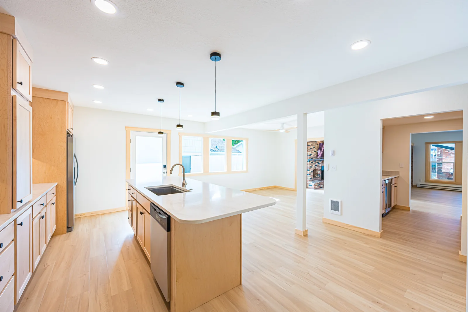 Maple kitchen island with a sink and dishwasher, open to the dining area, remodeled by CKS Builders LLC