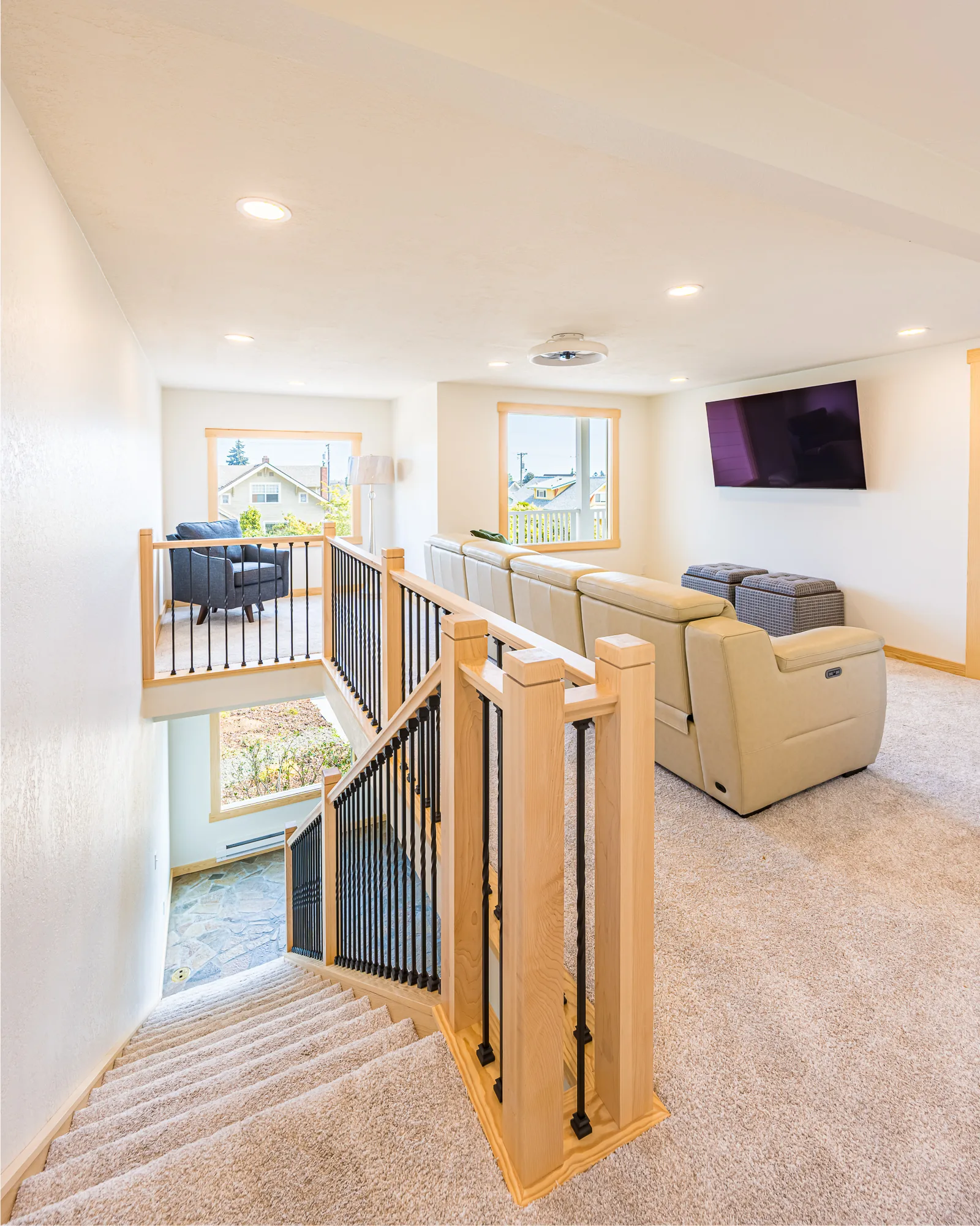 Upstairs landing and sitting area with maple and black metal stair railings, remodeled by CKS Builders LLC