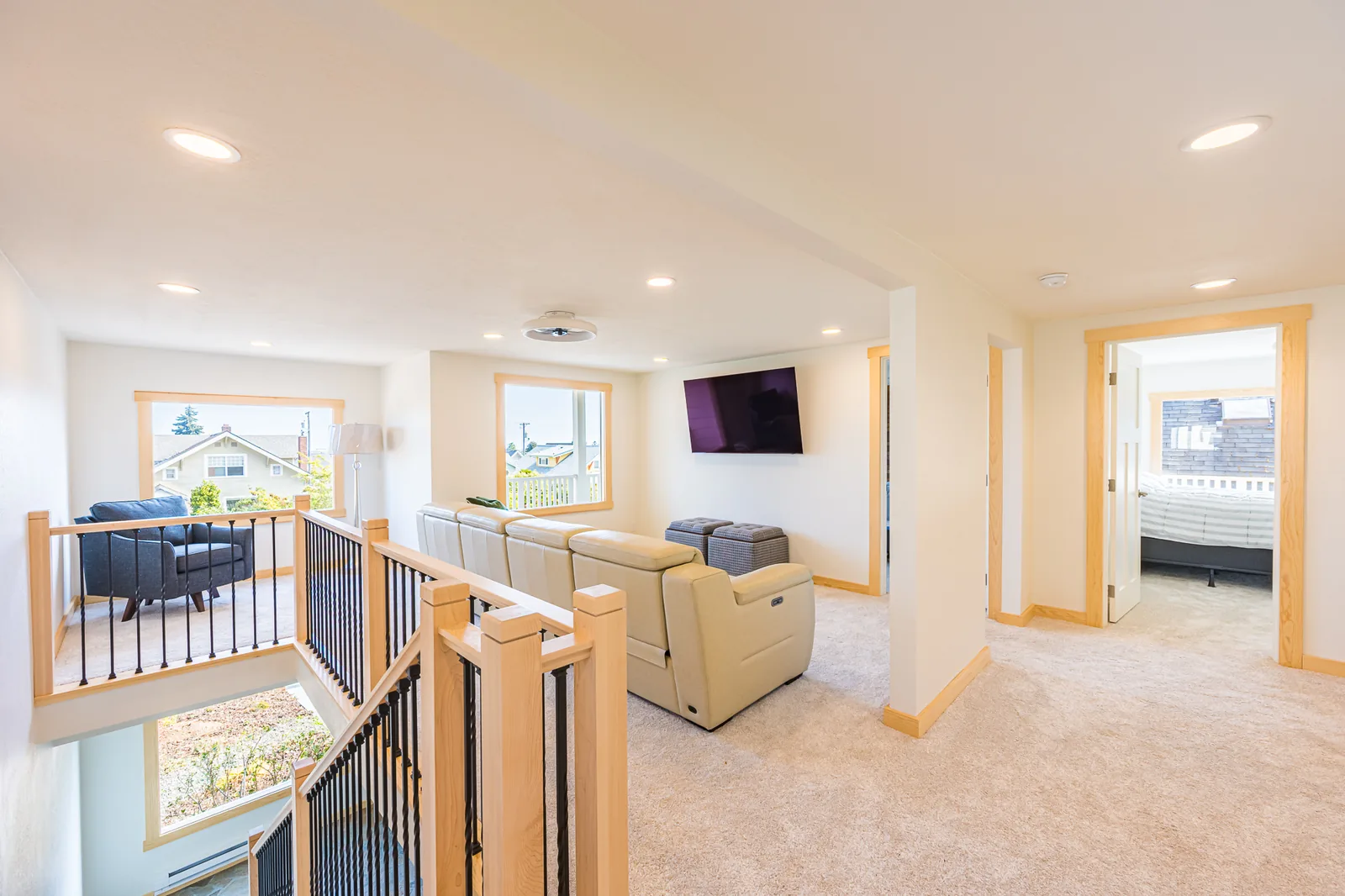 Upstairs sitting area beside the stair railing, with doors to the bedrooms, in a home remodeled by CKS Builders LLC