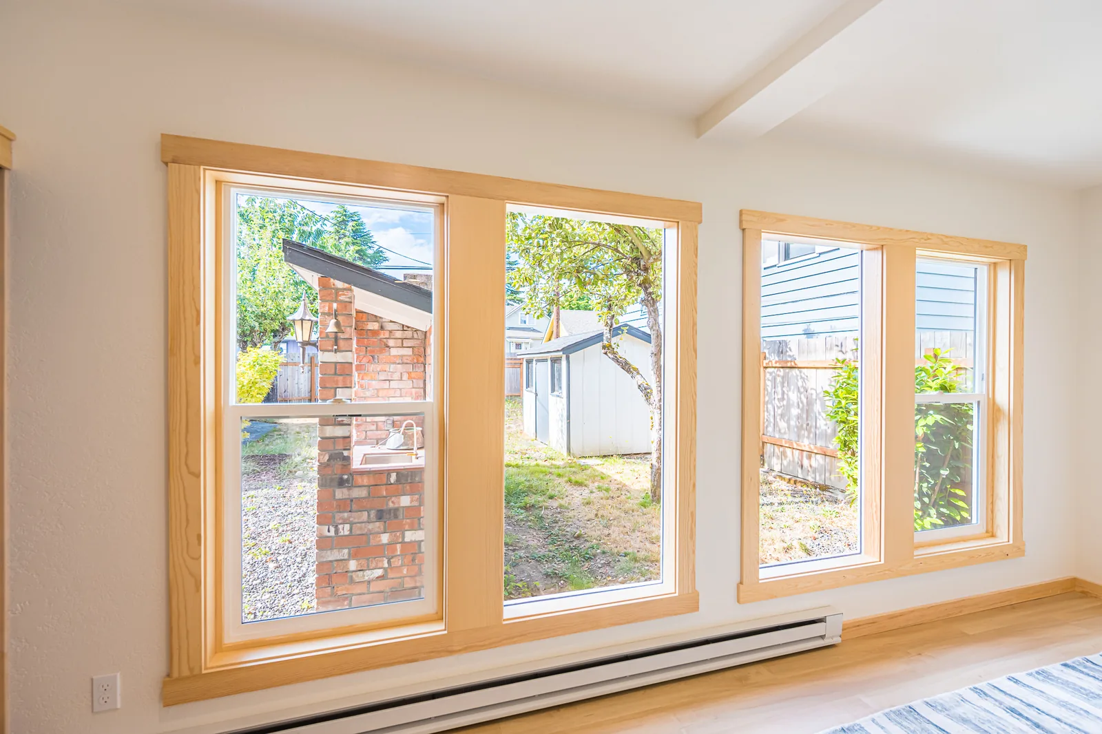 Wood-trimmed windows looking out to the backyard in a home remodeled by CKS Builders LLC